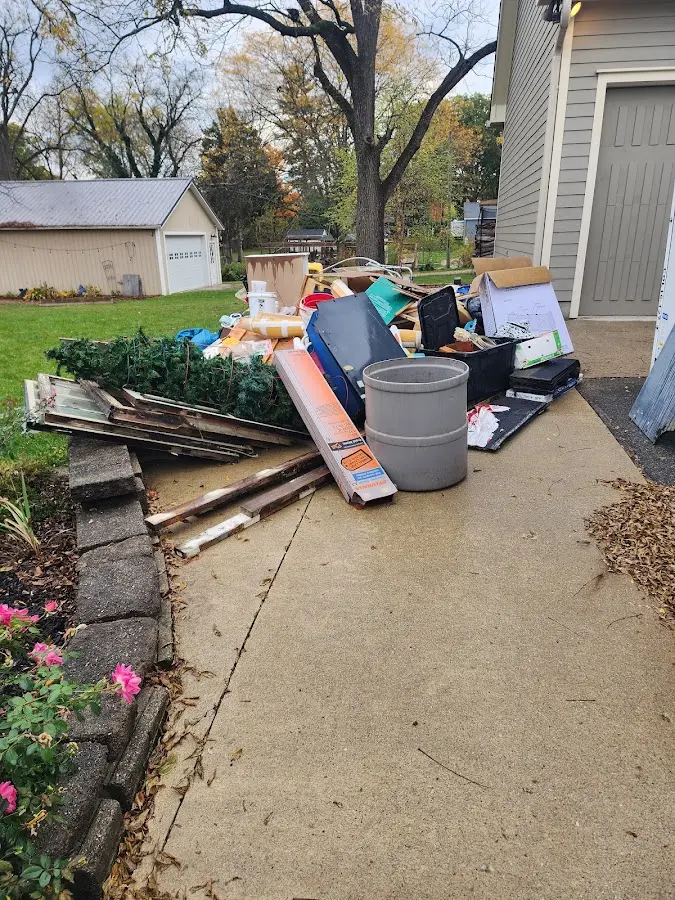 Dumpster being loaded with debris for Roofing Dumpster Rental in Bern